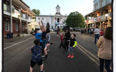 Kids play with a football on the street closed for the festival. #dadlife