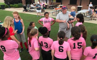 The OPC Pink Bombers gather around Coach Mize. Somehow NeNe’s brother got in the mix. ;) #dadlife