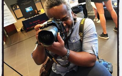 Photojournalist and instructor Tim Ivy hard at work at the Farley lawn party. #umjourimc #mississippijourno